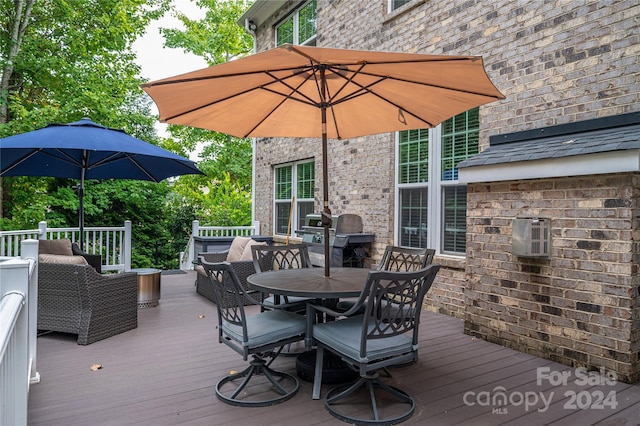 wooden terrace with outdoor dining area and grilling area