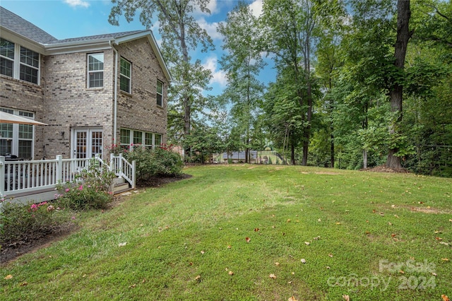 view of yard with a deck and fence