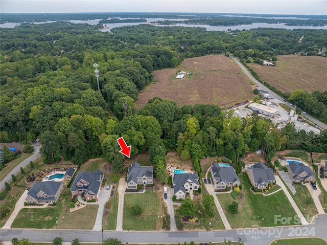 drone / aerial view featuring a forest view and a residential view