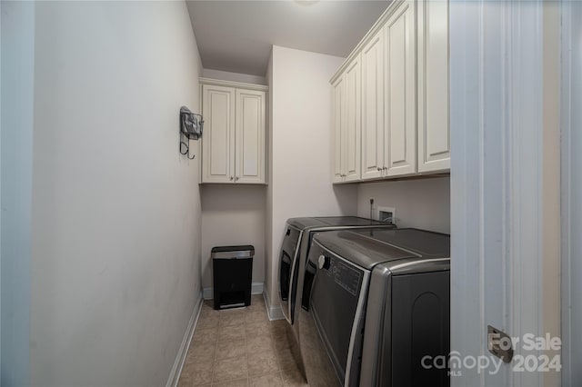 laundry room with cabinets and washing machine and dryer