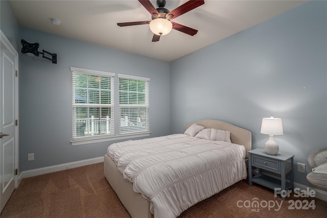 bedroom featuring dark colored carpet and ceiling fan