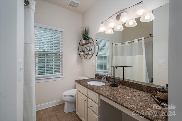 bathroom featuring visible vents, toilet, tile patterned flooring, baseboards, and vanity
