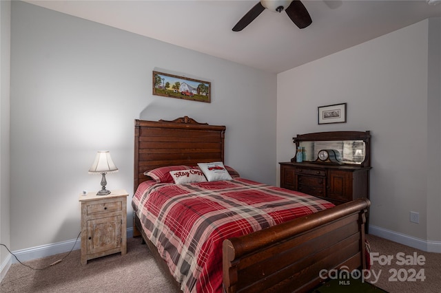 bedroom featuring baseboards, light carpet, and a ceiling fan