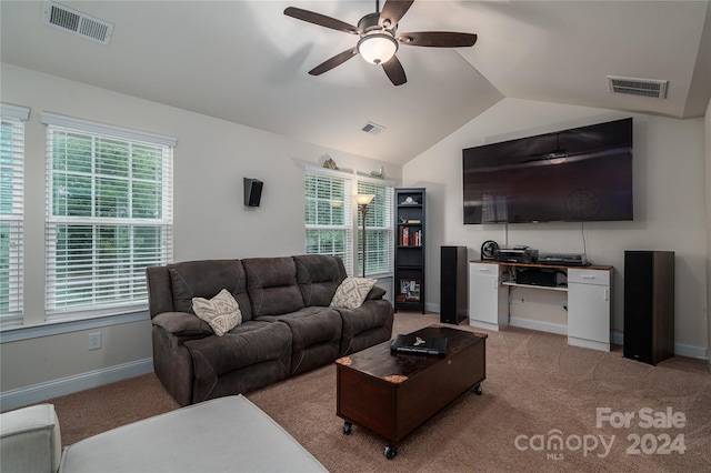 carpeted living area with visible vents, baseboards, ceiling fan, and vaulted ceiling