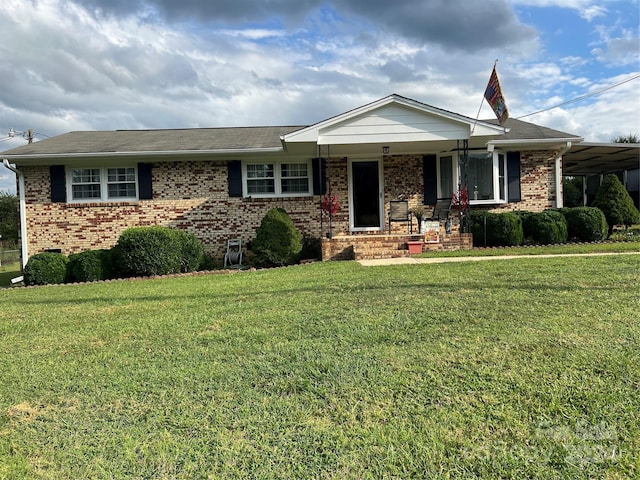 single story home with brick siding, covered porch, and a front yard