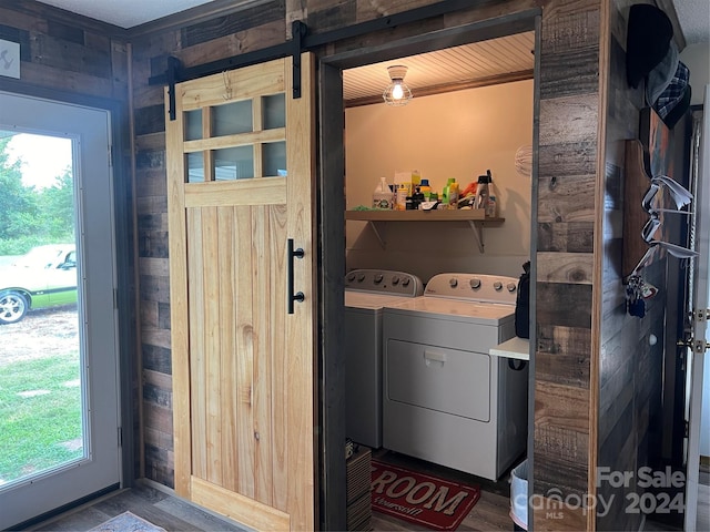 laundry room with laundry area, a barn door, and separate washer and dryer