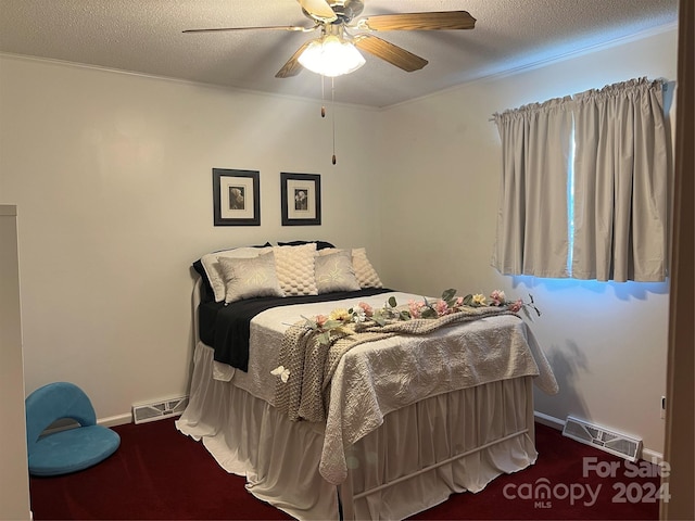 bedroom with visible vents, a textured ceiling, and ceiling fan