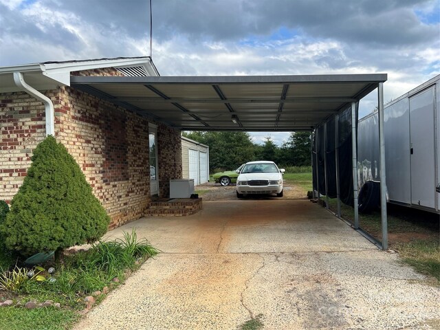 view of parking / parking lot with a carport and driveway