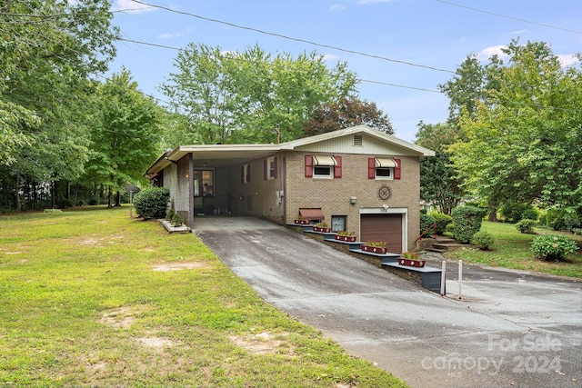 view of front of home featuring a front yard, a garage, and a carport