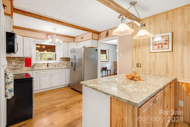 kitchen with pendant lighting, white cabinets, and stainless steel appliances