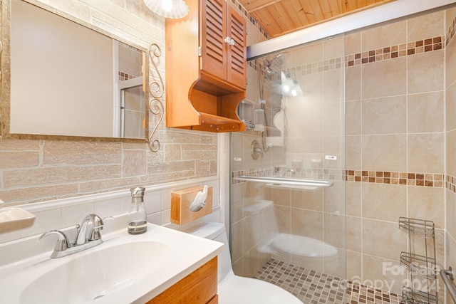 bathroom with vanity, a shower with shower door, and toilet