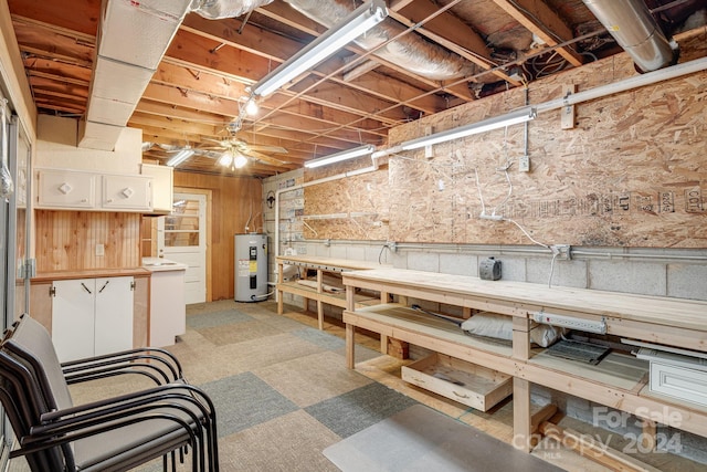 basement with water heater and a workshop area