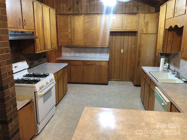 kitchen with sink, white appliances, and tasteful backsplash