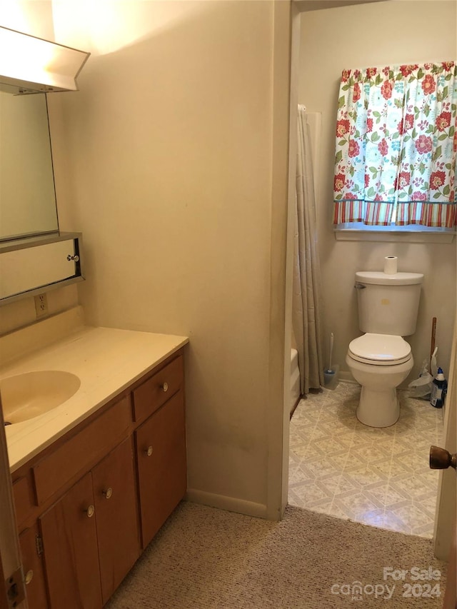 full bathroom featuring vanity, shower / tub combo, and toilet