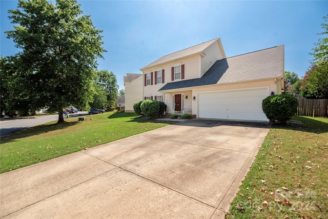 view of front of home with a front yard, an attached garage, fence, and concrete driveway