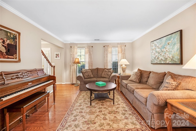 living room with crown molding and light wood-type flooring