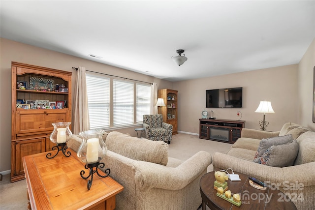 carpeted living room with a fireplace