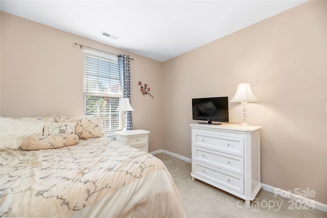 bedroom featuring light colored carpet