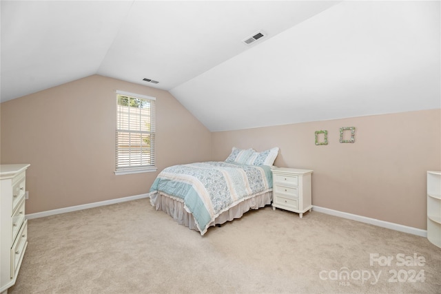 bedroom with light carpet and vaulted ceiling