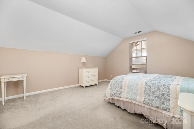 bedroom with light carpet and vaulted ceiling