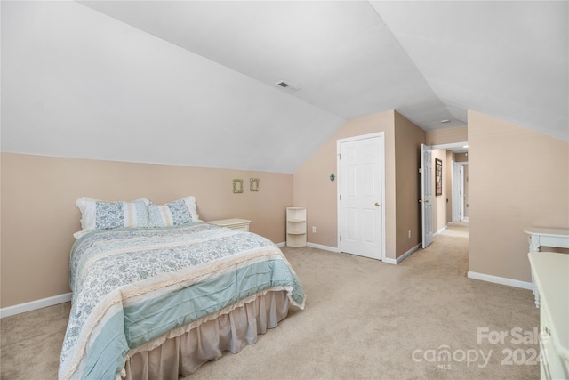 carpeted bedroom featuring lofted ceiling