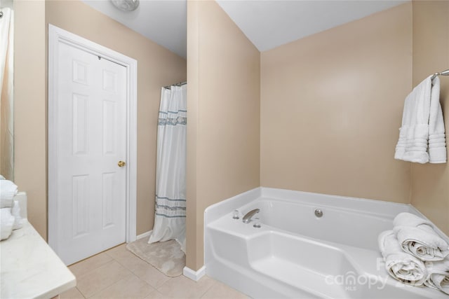 bathroom with a bathing tub and tile patterned flooring