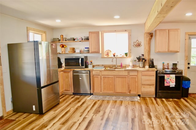 kitchen featuring light hardwood / wood-style flooring, light brown cabinets, stainless steel appliances, and sink