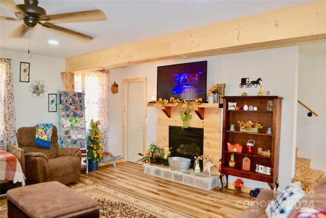 living room featuring hardwood / wood-style floors and ceiling fan