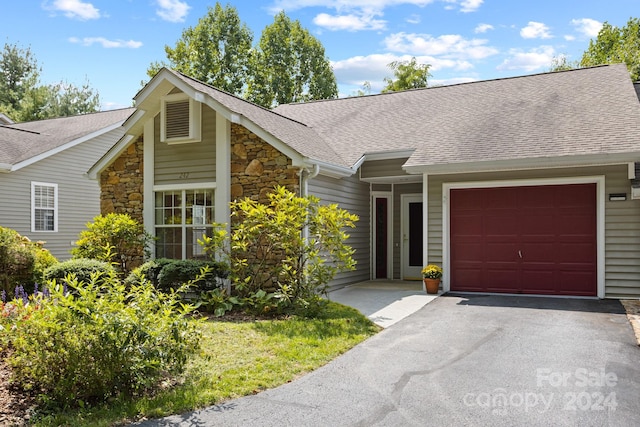 single story home featuring a garage