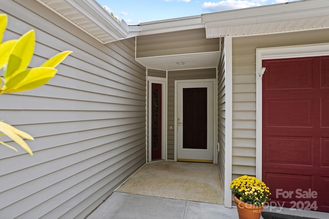 doorway to property with a garage