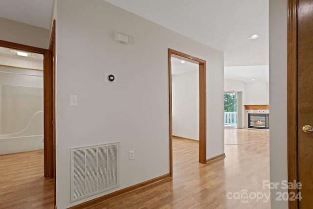 hallway with light hardwood / wood-style flooring