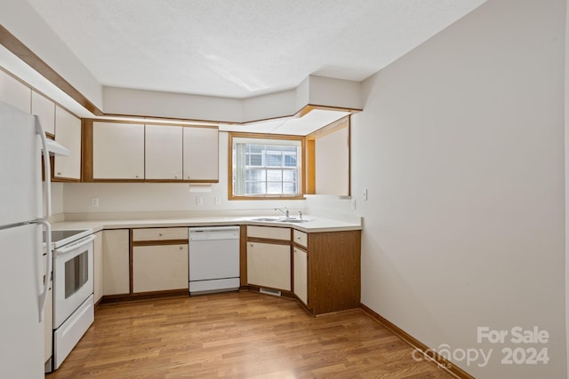 kitchen with a textured ceiling, sink, white cabinetry, light hardwood / wood-style flooring, and white appliances