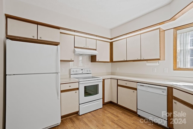 kitchen featuring light wood-type flooring, white appliances, and white cabinets