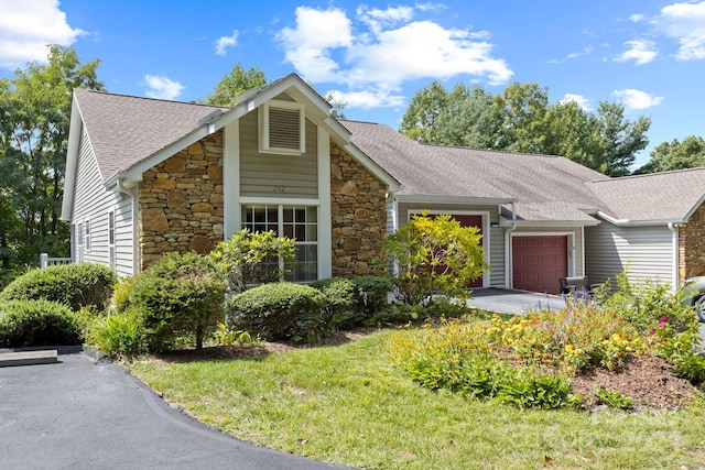 single story home featuring a garage and a front lawn