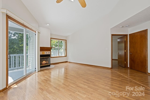 unfurnished living room featuring ceiling fan, light hardwood / wood-style flooring, and a wealth of natural light