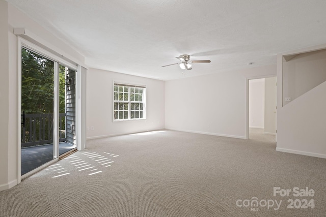 carpeted empty room featuring ceiling fan