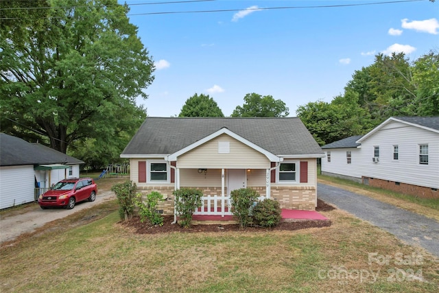 view of front of home with a front yard and a porch