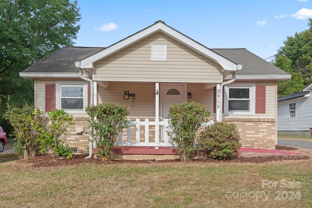 bungalow featuring a front yard and a porch