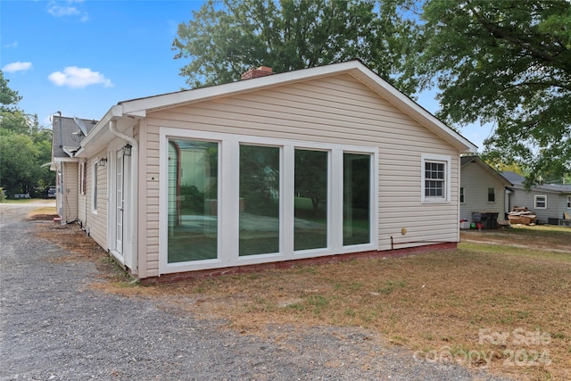 rear view of property featuring a yard