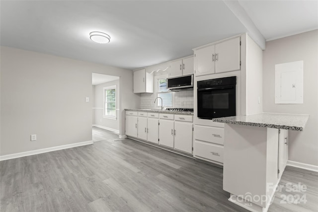 kitchen with light hardwood / wood-style flooring, stainless steel appliances, and white cabinets