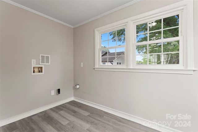 clothes washing area with washer hookup, hardwood / wood-style flooring, and crown molding