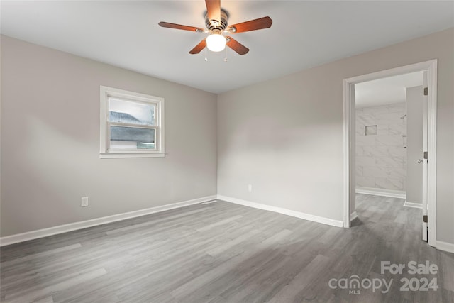 spare room with ceiling fan and hardwood / wood-style floors