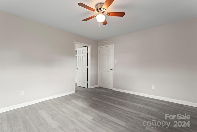 empty room with ceiling fan and hardwood / wood-style floors