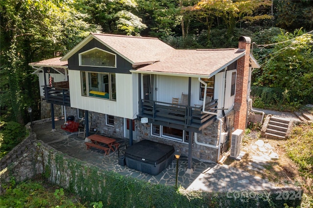 view of front facade with a patio and central AC