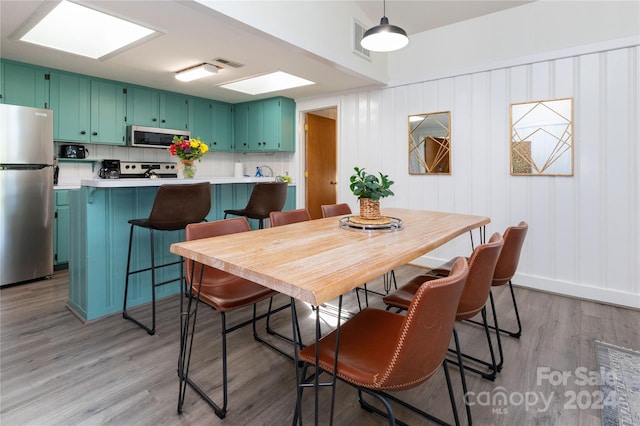 dining space with light hardwood / wood-style flooring