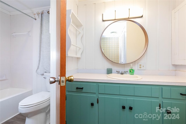 full bathroom with vanity, crown molding, toilet, hardwood / wood-style flooring, and washtub / shower combination