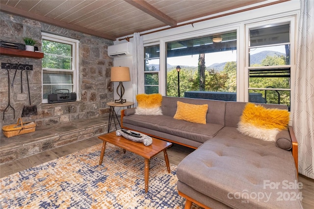 living room with a wall unit AC, wooden ceiling, a mountain view, wood-type flooring, and beam ceiling