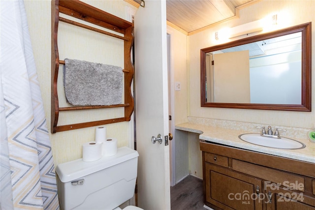 bathroom with hardwood / wood-style floors, toilet, and vanity