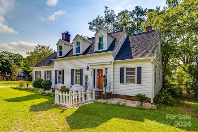 cape cod home with a front yard