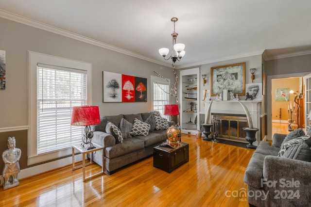 living room featuring an inviting chandelier, ornamental molding, and hardwood / wood-style floors